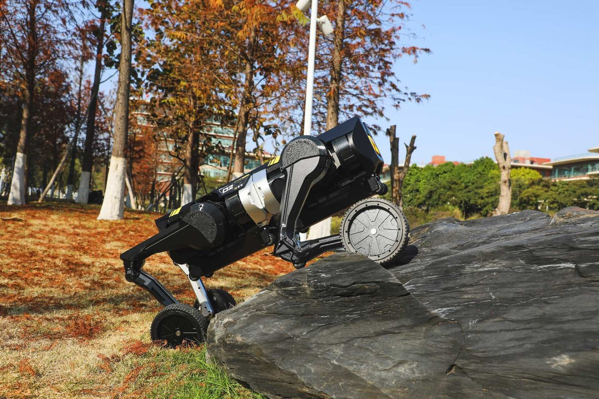 Direct Drive Tech wheeled-leg robot crossing outdoor terrain